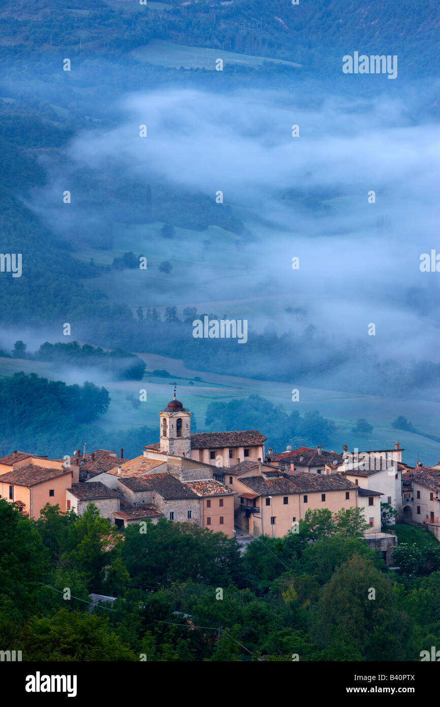 the village of Castelvecchio with mist lying in the Valnerina at dawn, Umbria, Italy Stock Photo