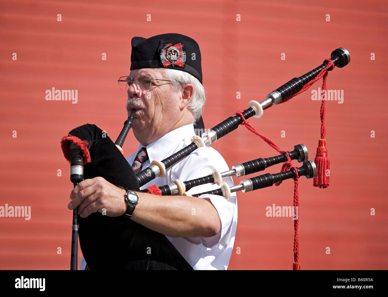 Male bagpiper playing Scottish music Stock Photo