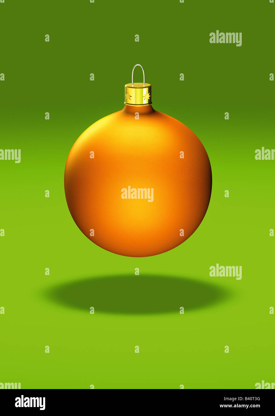 yellow christmas ball ornament on green backgrund gelbe Christbaumkugel auf gruenem Hintergrund Stock Photo