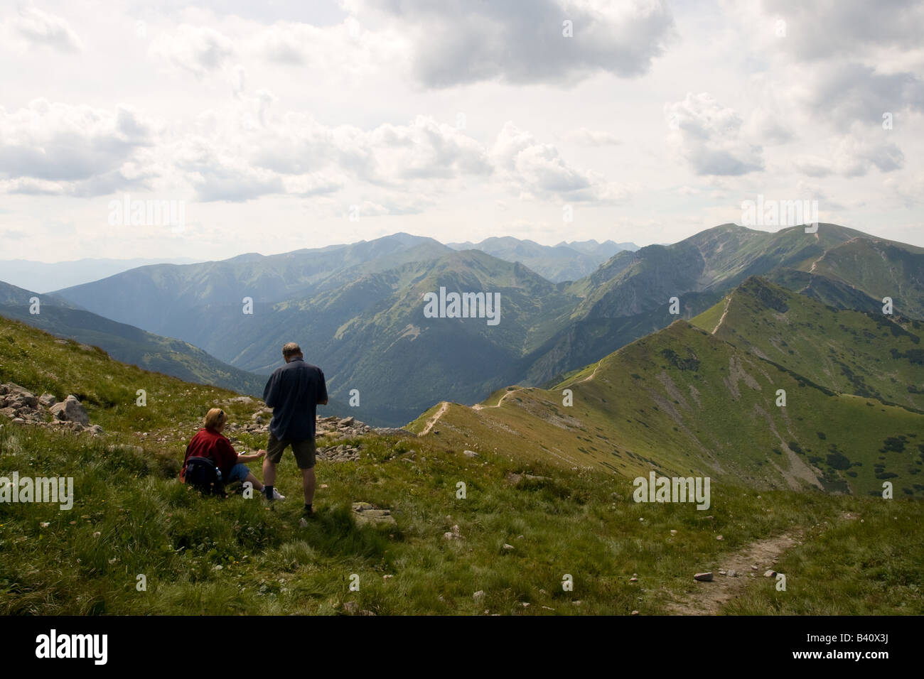 Two men admire the view from the top of the mountain Kasprowy Wierch, located in the Western Tatras mountains of Zakopane Poland Stock Photo