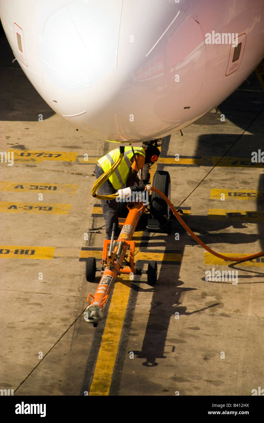 Palma Mallorca Balearic Islands Spain Ground crew attaches a tow bar to an airbus at the airport Stock Photo