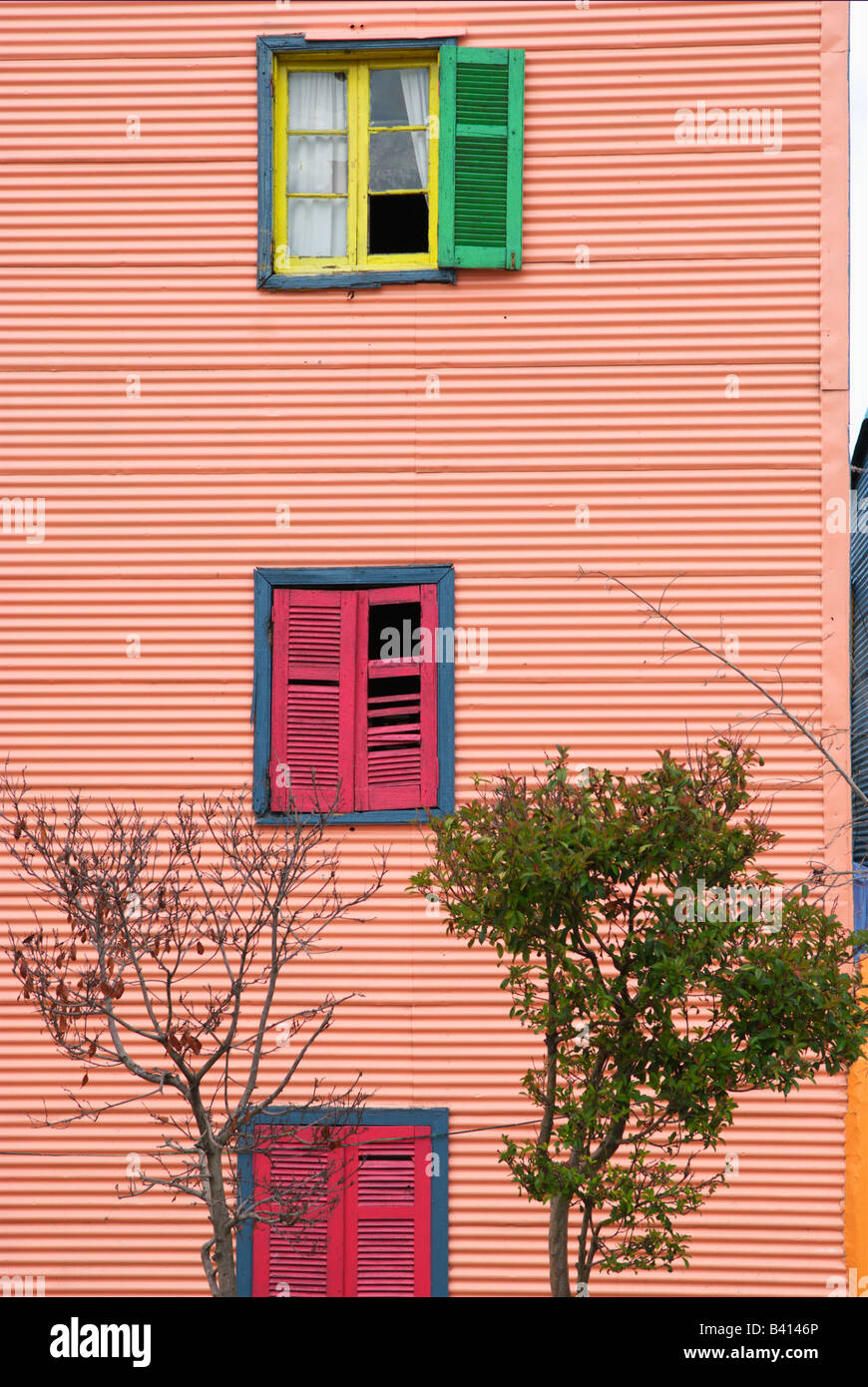 House made of corrugated iron with colorful shutters Stock Photo