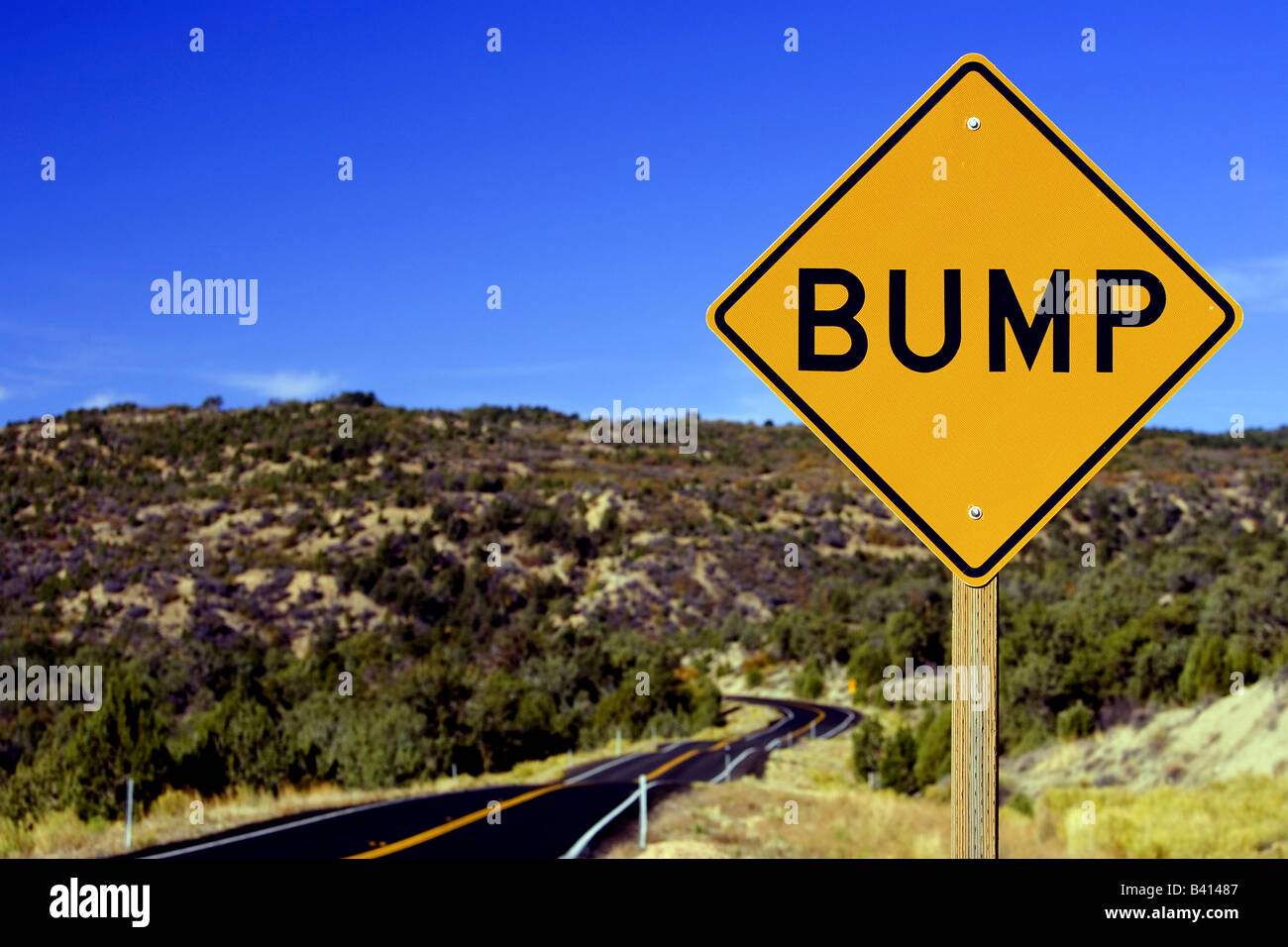 A roadside view of a bumpy road and bump warning sign Stock Photo - Alamy