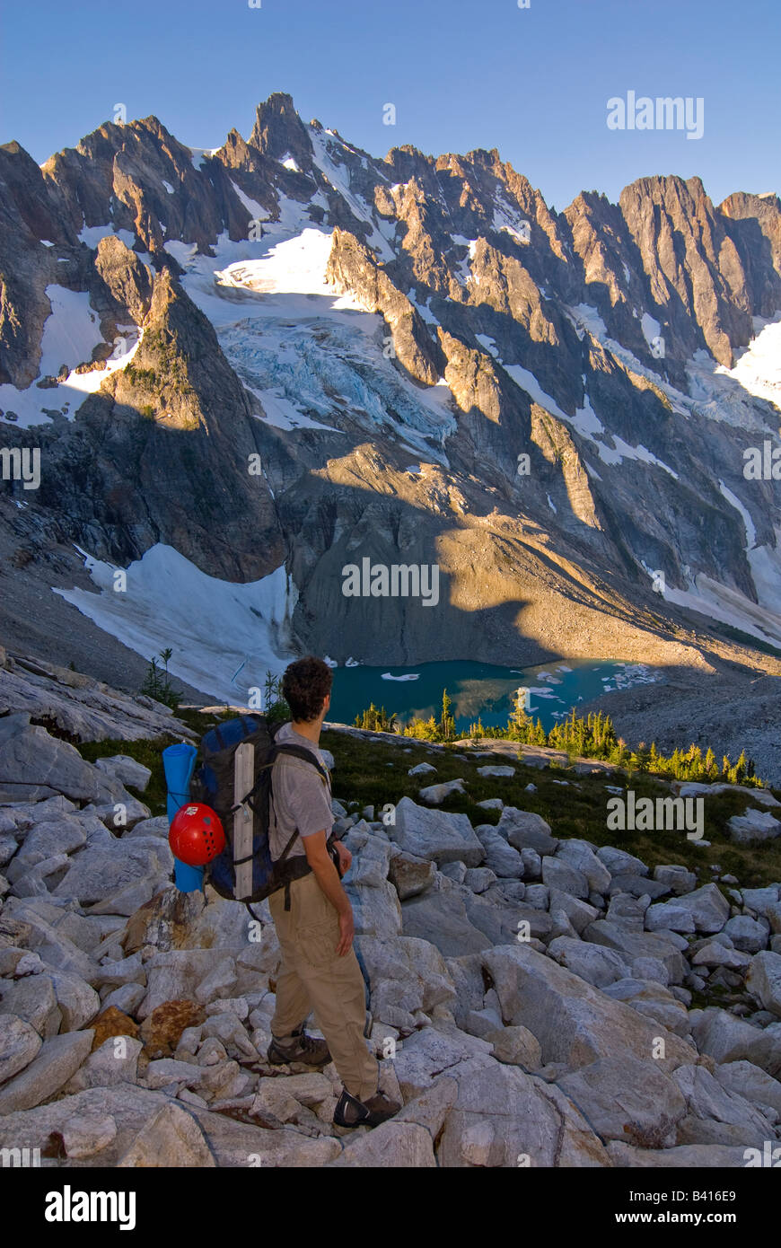 USA, Washington, North Cascades Nat'l Park. A backpacker gazes out at