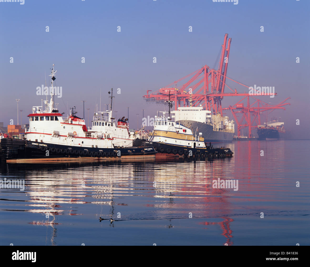 WA, Seattle, Tug boats and container ships at the Port of Seattle on ...