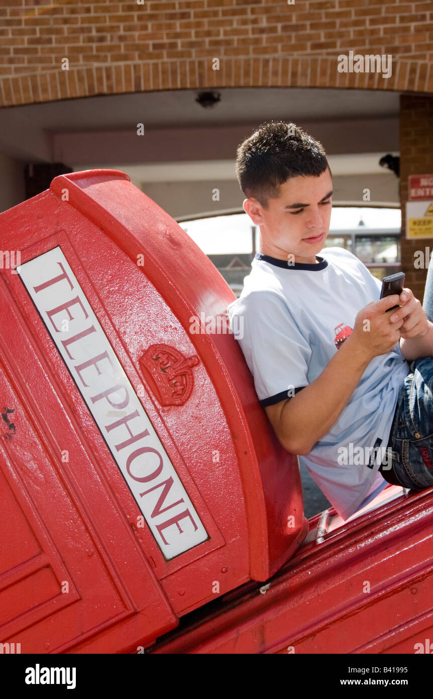Teenage boys in Street mobile phones fighting drinking smoking Model  Released Shoot No 3643 Stock Photo - Alamy