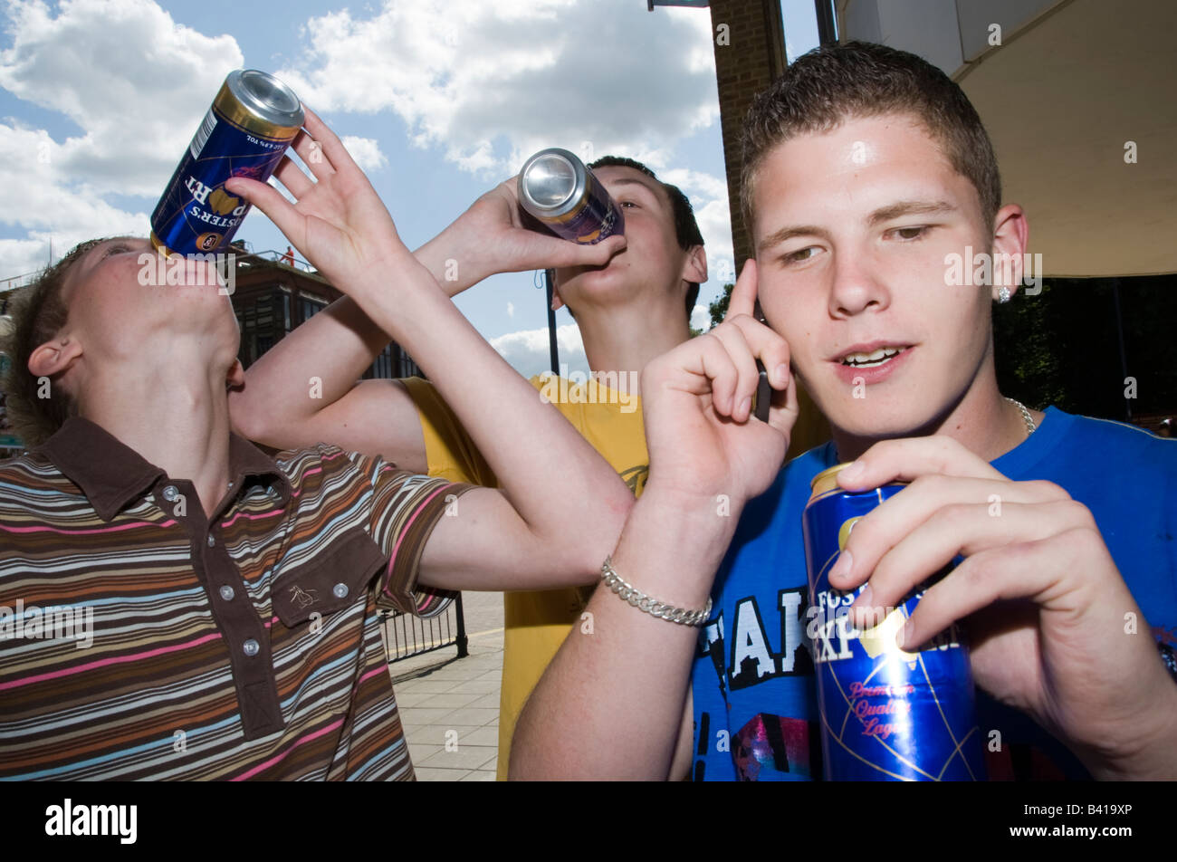 Teenage boys in Street mobile phones fighting drinking smoking Model  Released Shoot No 3643 Stock Photo - Alamy