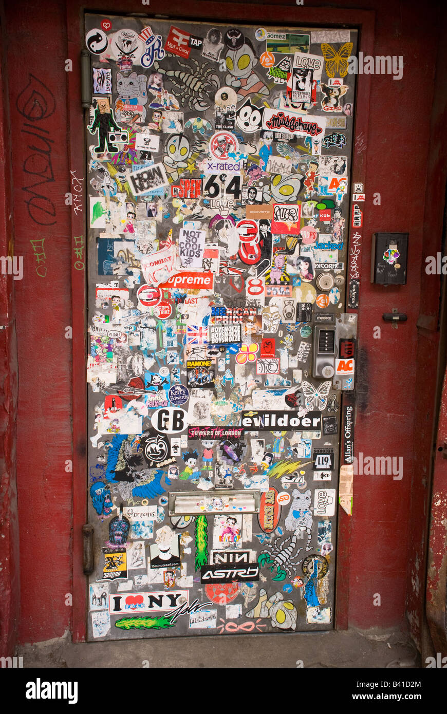 Ripped and torn posters decorate a doorway to one of the warehouses in