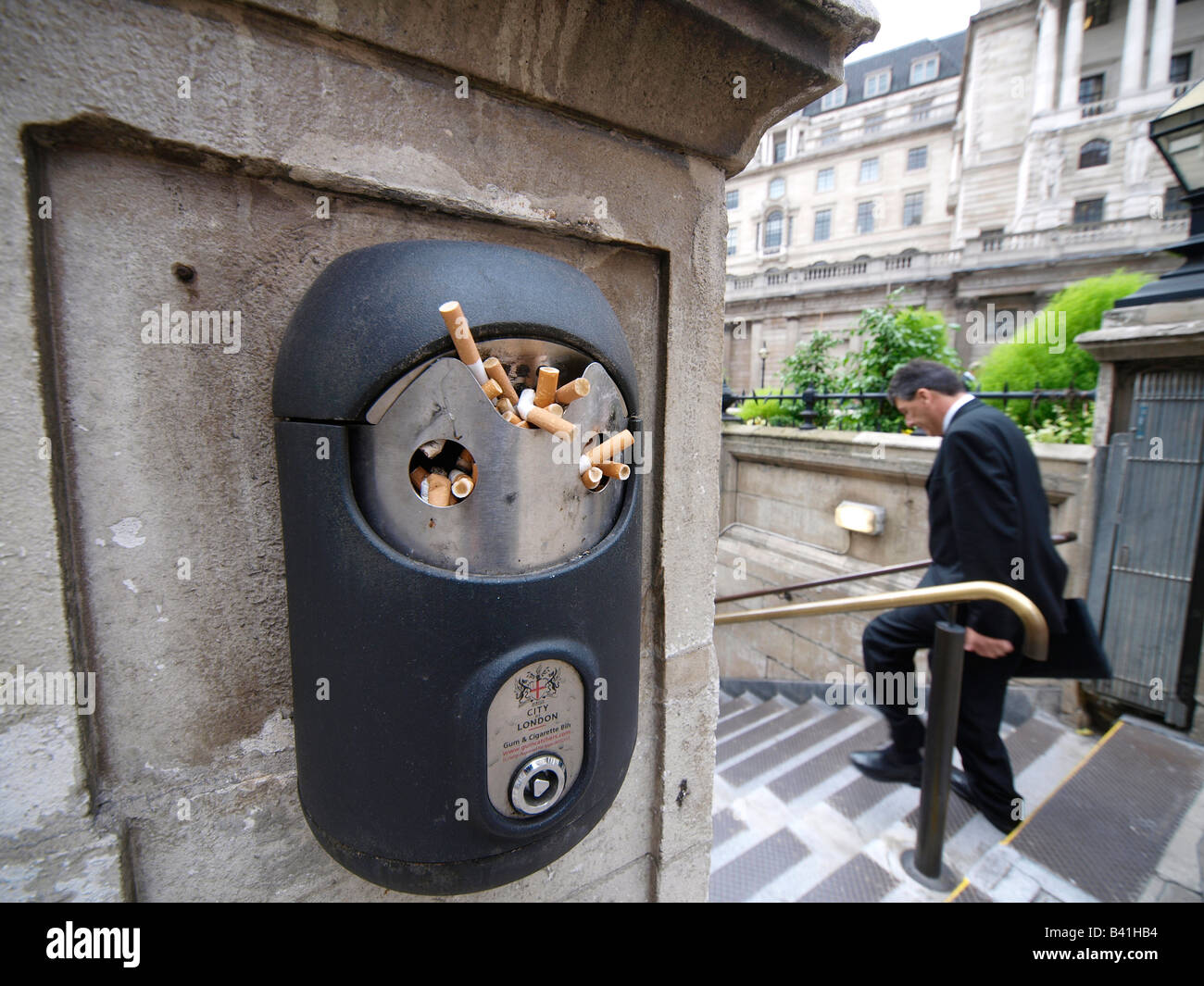 Overflowing gum and cigarette bin at the entrance of Bank station of
