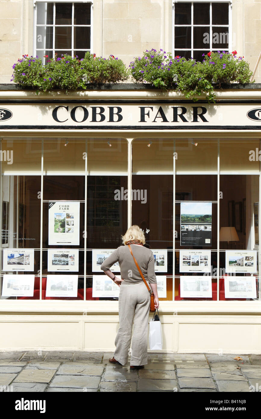 Bath England one woman looking at the window display at Cobb Farr