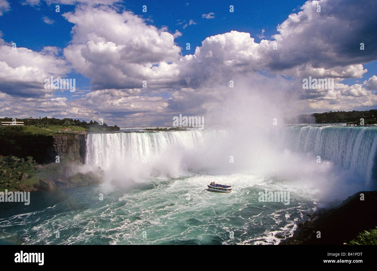 A rainbow and a view of Niagara Falls from the Canadian side and the Queen of the Mist tour boat Stock Photo