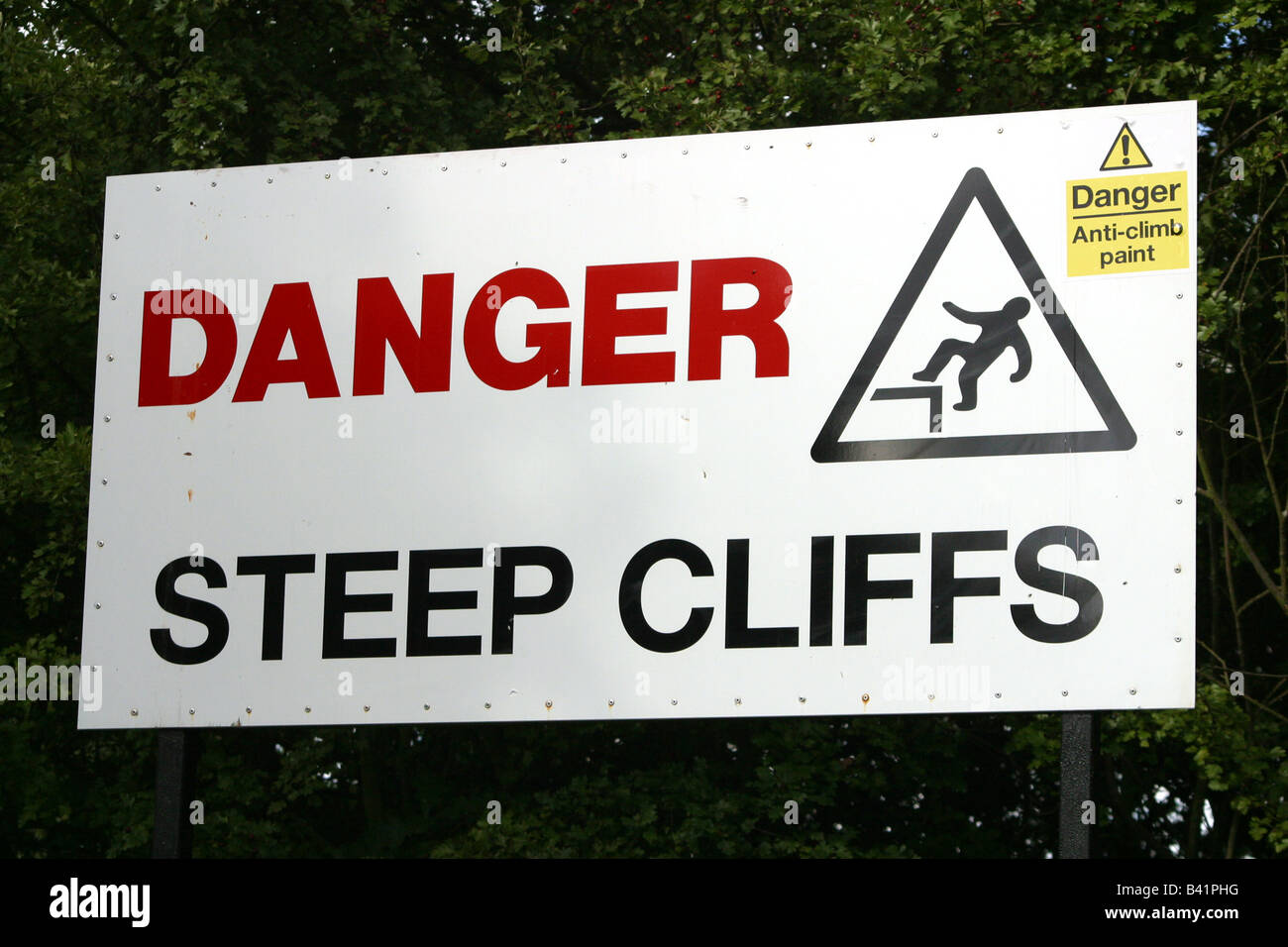 steep cliff sign with do not climb sticker Stock Photo
