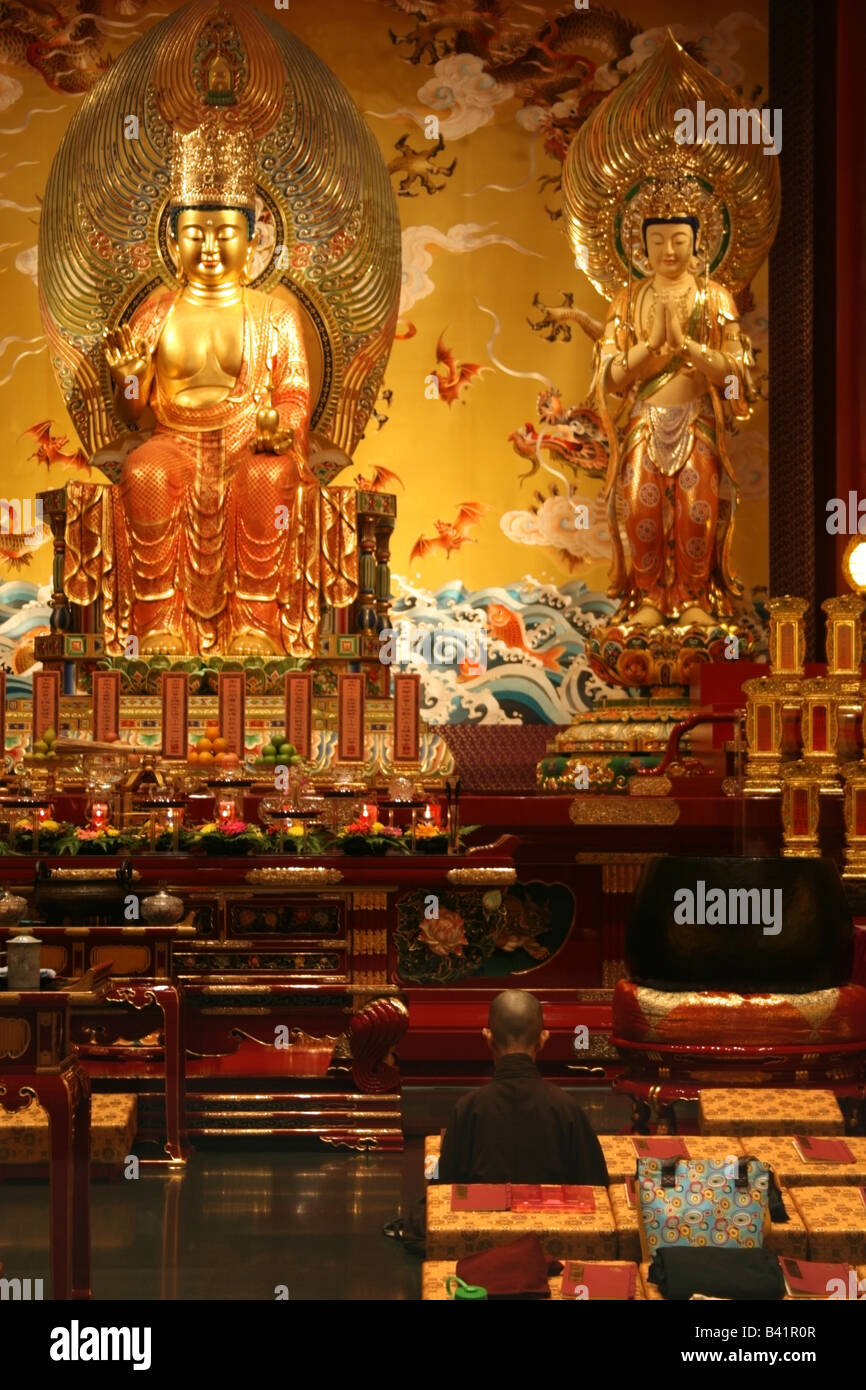 Buddhist follower or nun worshipping at The Buddha Tooth Relic temple Singapore South East Asia Stock Photo