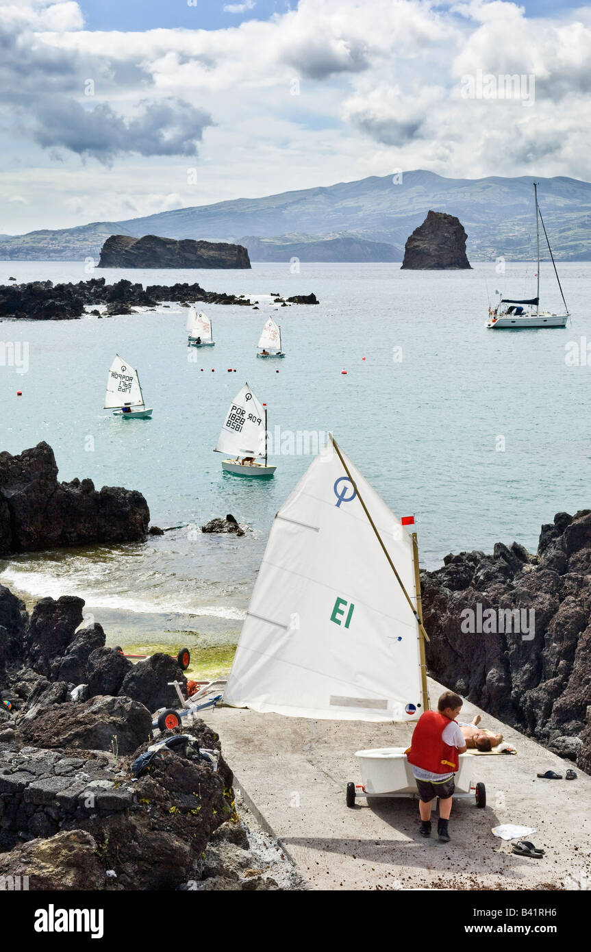 Optimist boat class training in the bay of Madalena Pico island Azores Stock Photo