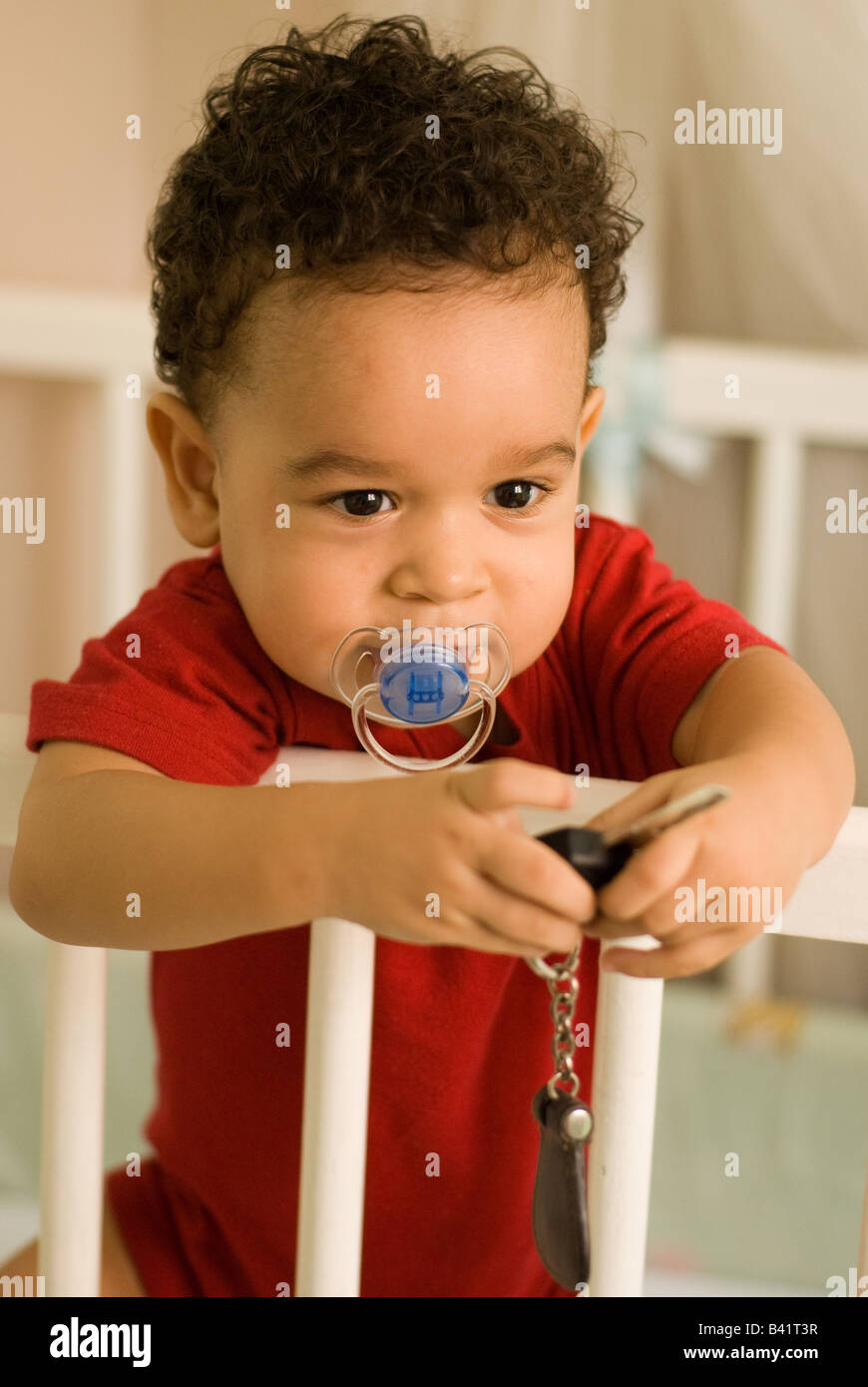 A portrait of a toddler in his cradle holding a car’s key Stock Photo Alamy