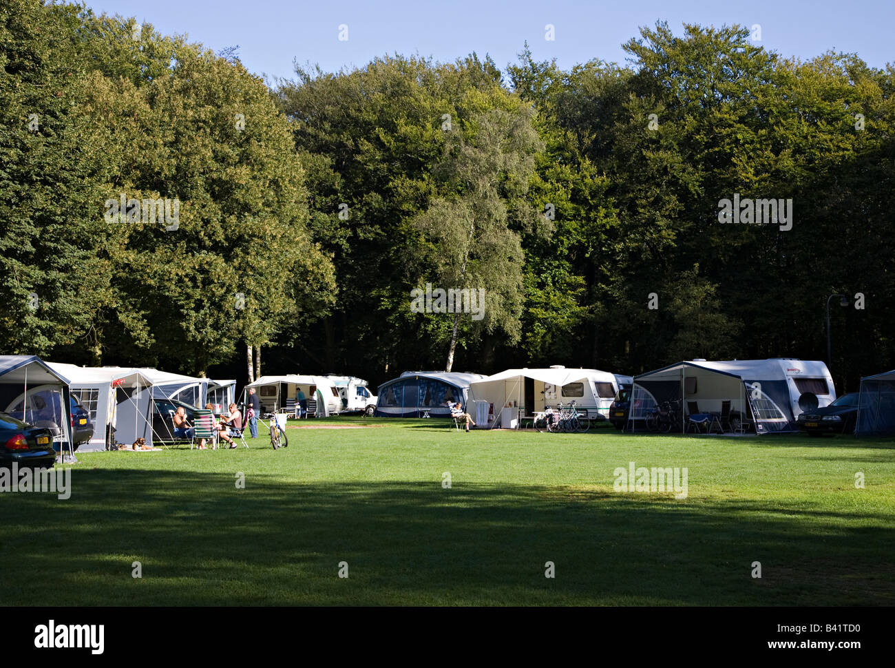 People relaxing with caravans and tents on campsite Netherlands Stock Photo