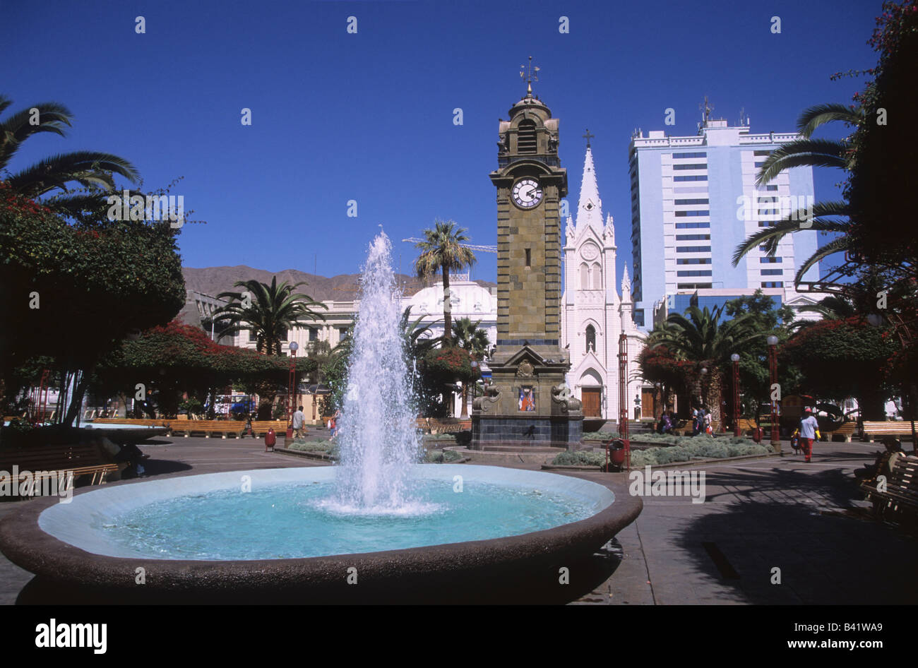 Fountain and clock tower in Plaza Colon, St. Joseph's / San José cathedral behind, Antofagasta, Chile Stock Photo