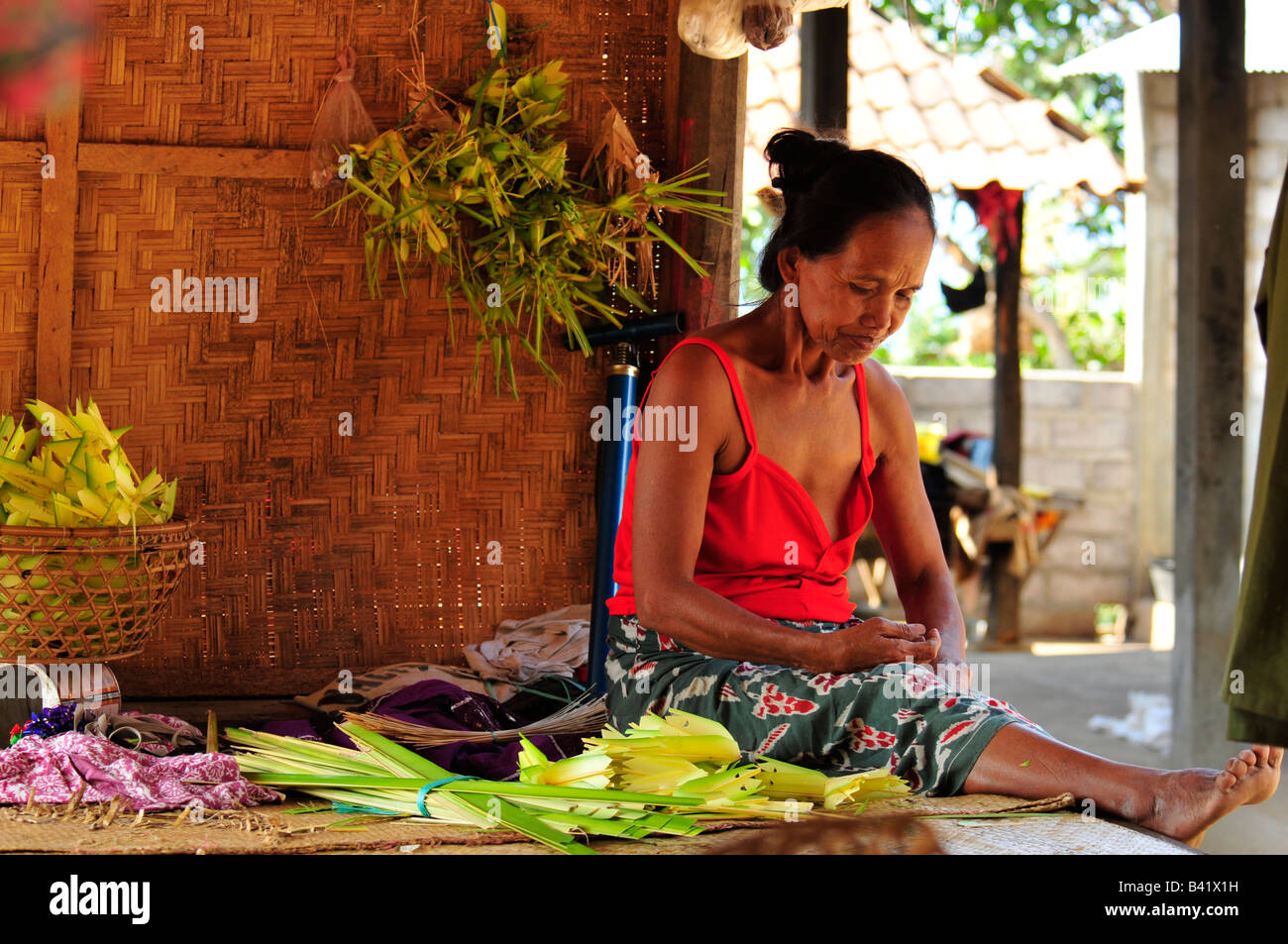 bali aga village life, old lady making temple offerings, semberan , bali , indonesia Stock Photo