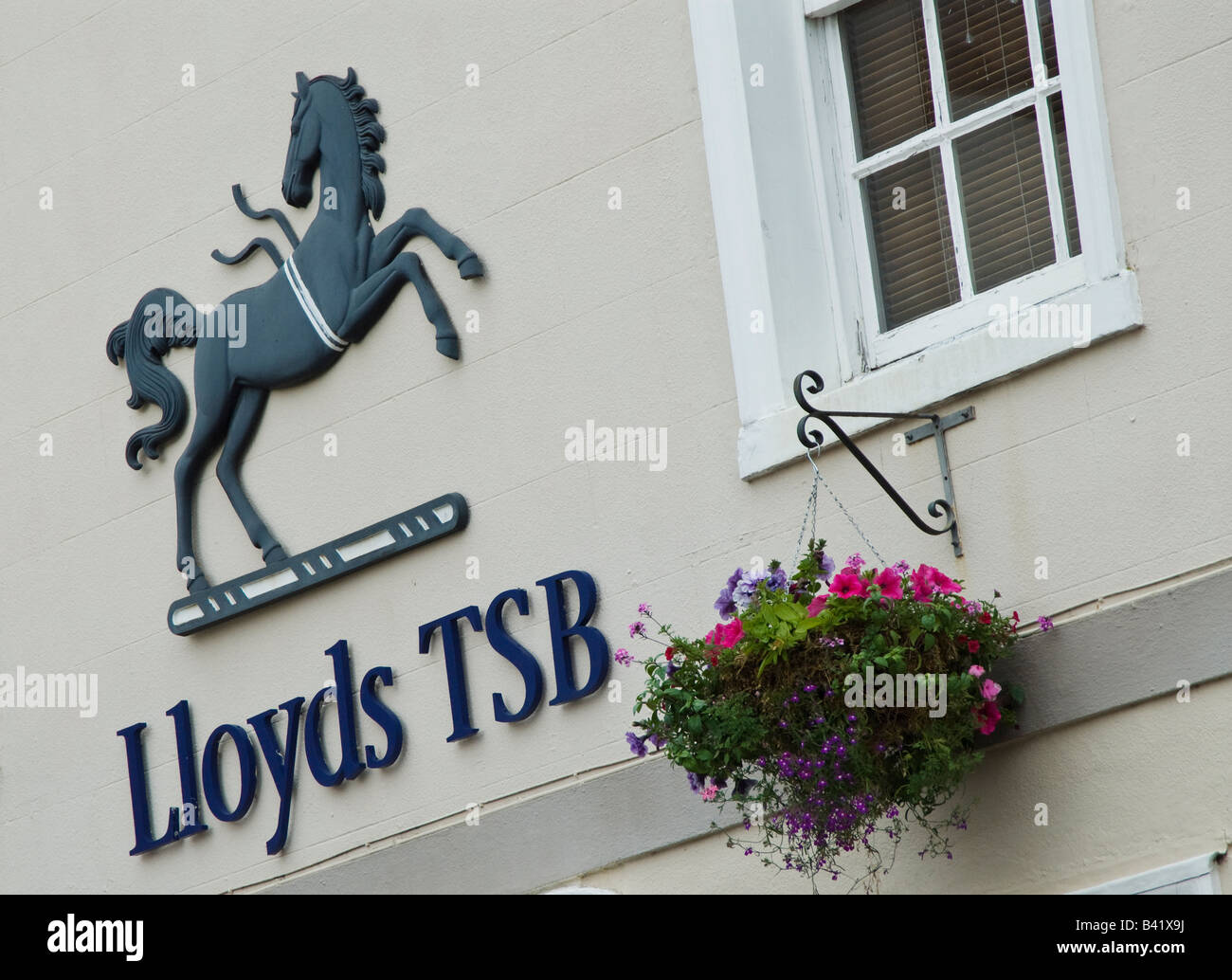 Lloyds TSB bank sign and hanging basket display at a bank in Warwickshire, UK. Stock Photo