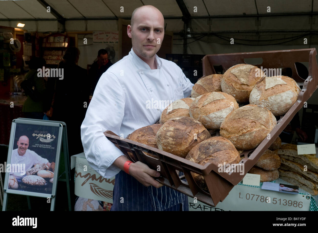 Alex Gooch specialist baker with a tray of his hand made loaves of organic fresh bread at Food festival Ludlow Shropshire UK Stock Photo