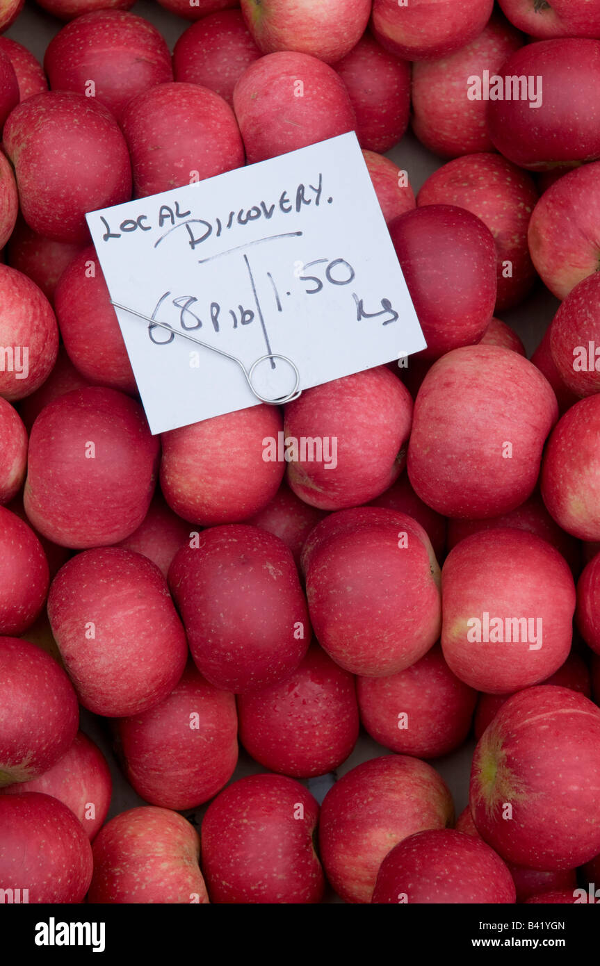 fresh local red Discovery apples on sale on market stall in Ludlow England UK Stock Photo