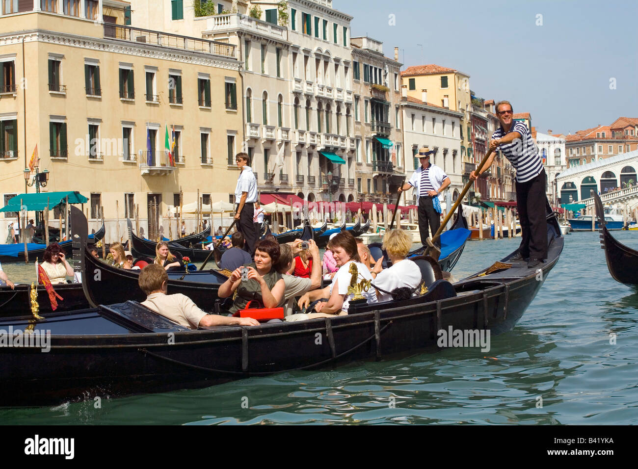 Taking a Gondola ride near the Rialto Bridge in Venice Italy Stock Photo