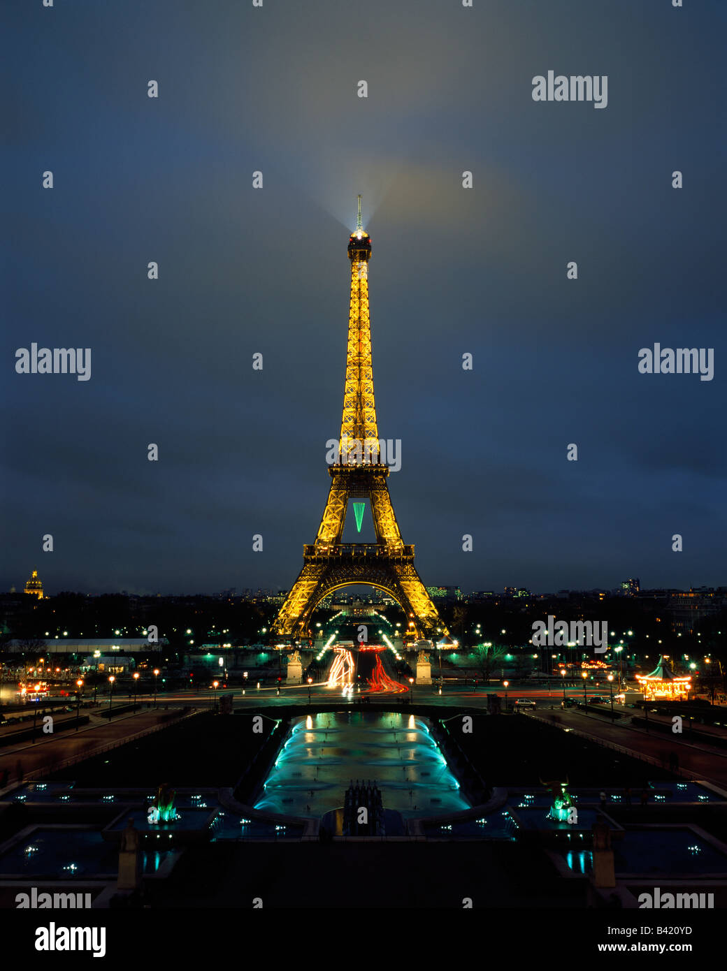 The iconic Eiffel tower (la Tour Eiffel) beams across the city of Paris in the twilight of a winter evening. Stock Photo