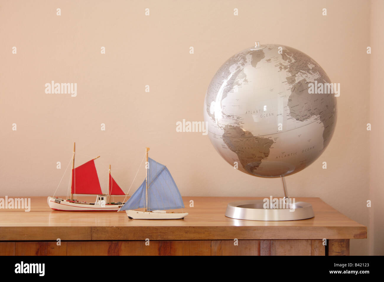 globe with two little boats on a commode Stock Photo