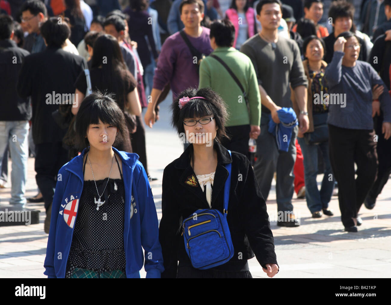 Two young girls walking on Wanfujing street, Beijing, China Stock Photo