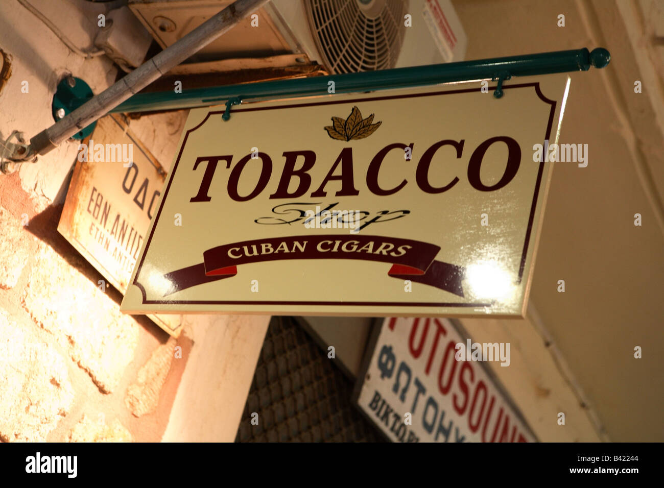 The sign outside a tobacco shop in Crete Greece at night Greece has one of the highest rates of
