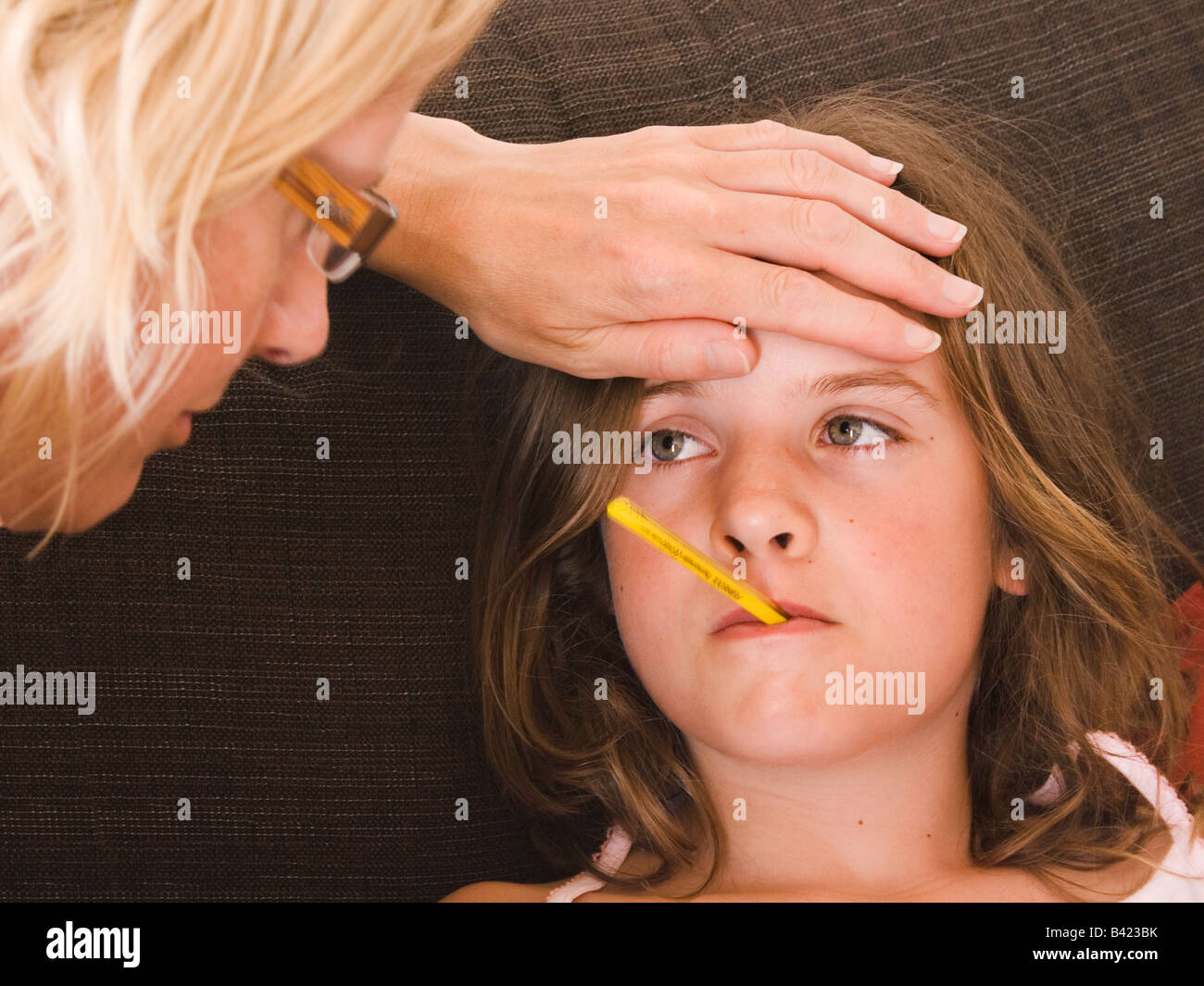 Mother and little girl with thermometer in mouth Stock Photo Alamy