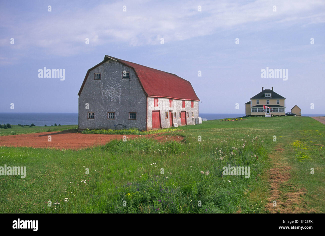 A lovely old barn and cliff side home on the East Cape Prince Edward Island Stock Photo Alamy