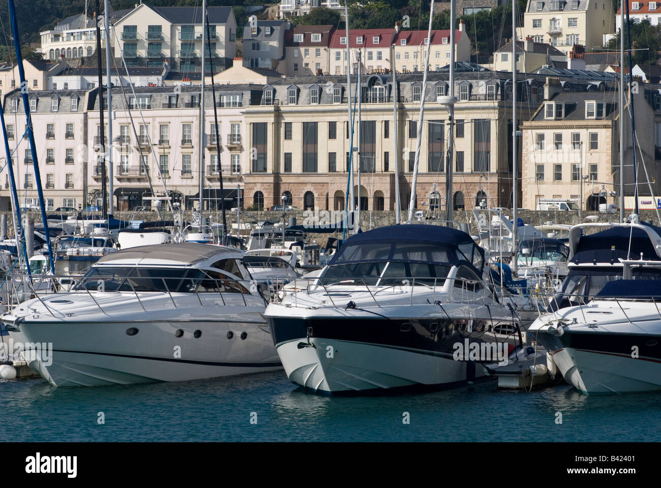 Financial centre and motor boats in marina, St Peter Port, Guernsey. Stock Photo