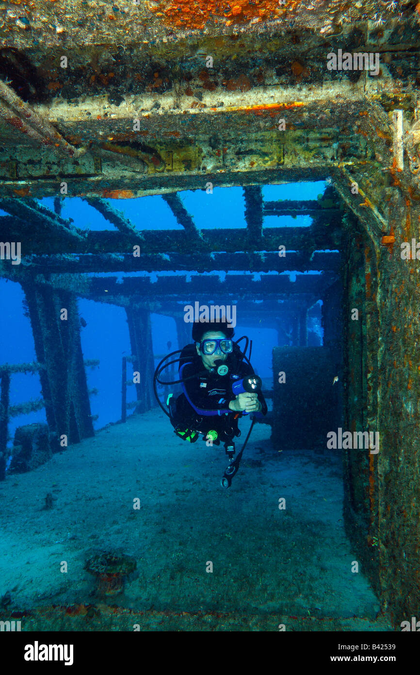 Young female diver exploring the exterior of the ship wreck of military ship 'Felipe Xicotencatl' C-53 class Stock Photo