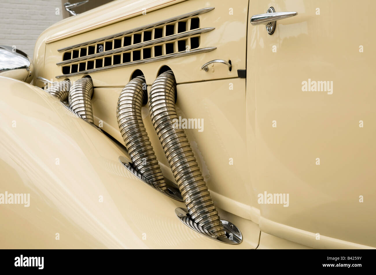 Header pipes -- chrome exhaust tubes -- on a refurbished 1935 Auburn 851 Stock Photo