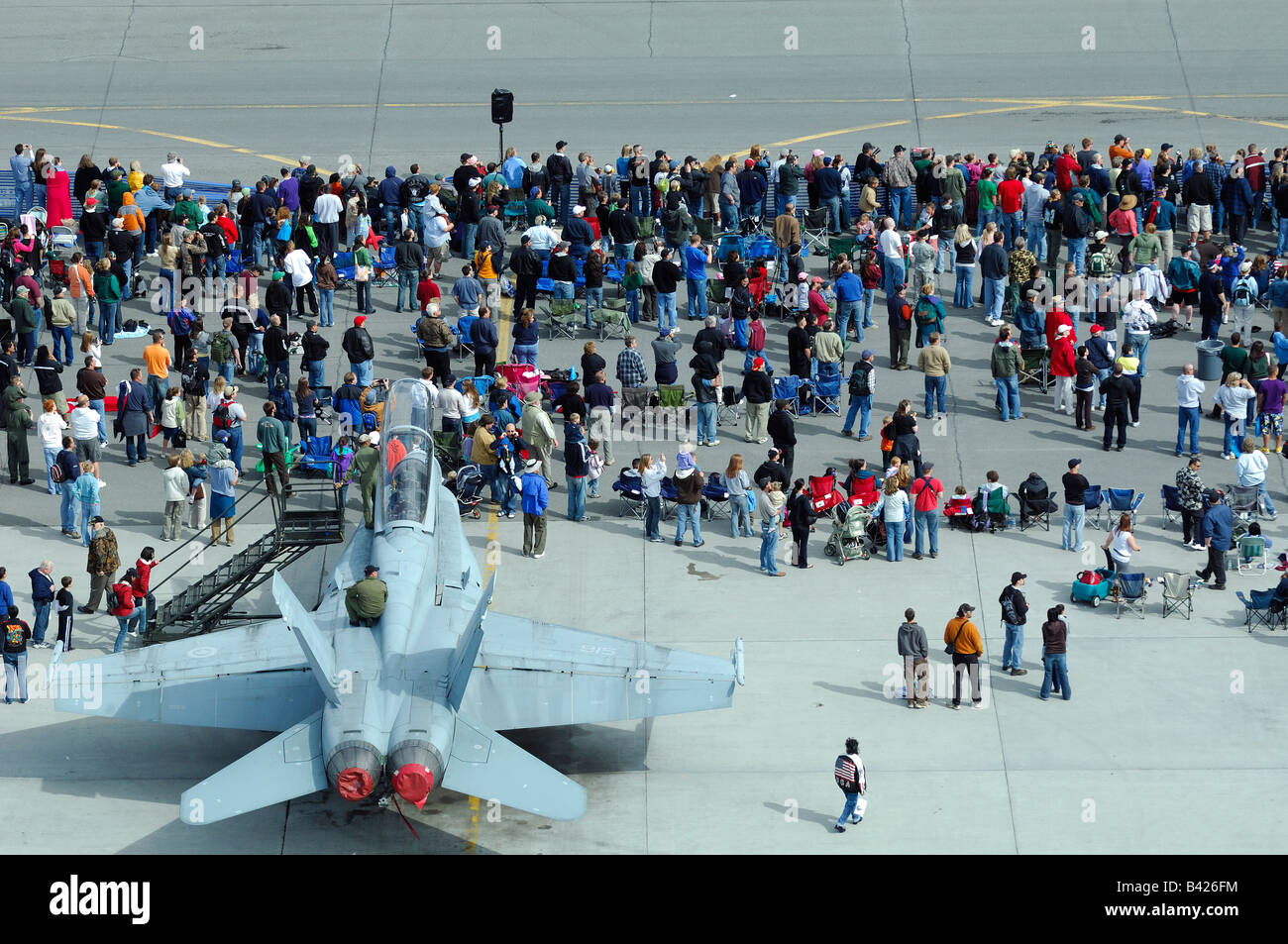Overview of spectators and jet fighter F18 on tarmac, Anchorage