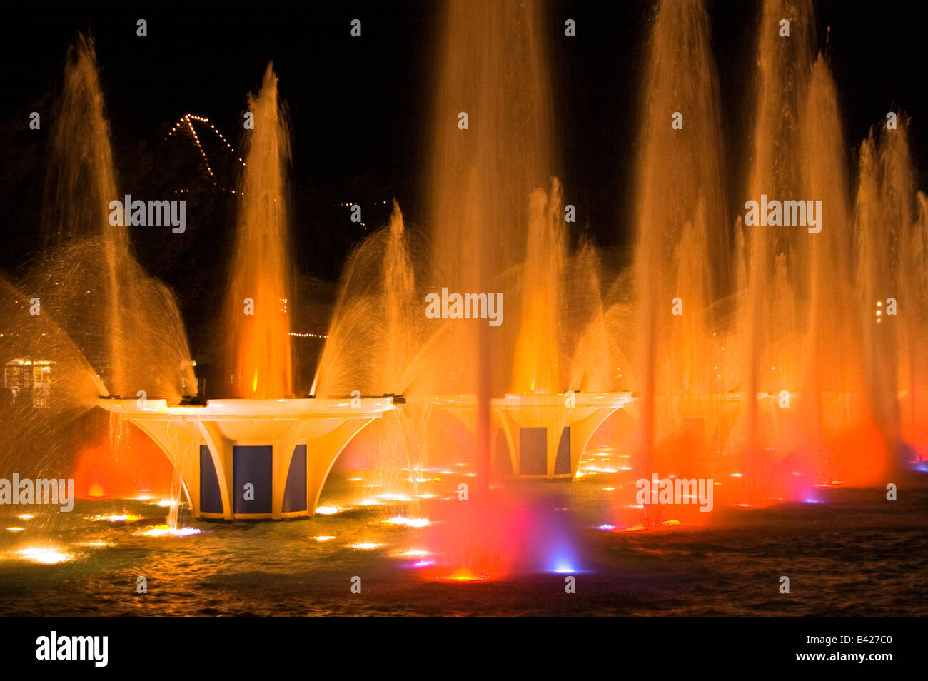 Water fountains with colorful lights glow in the darkness Stock Photo Alamy
