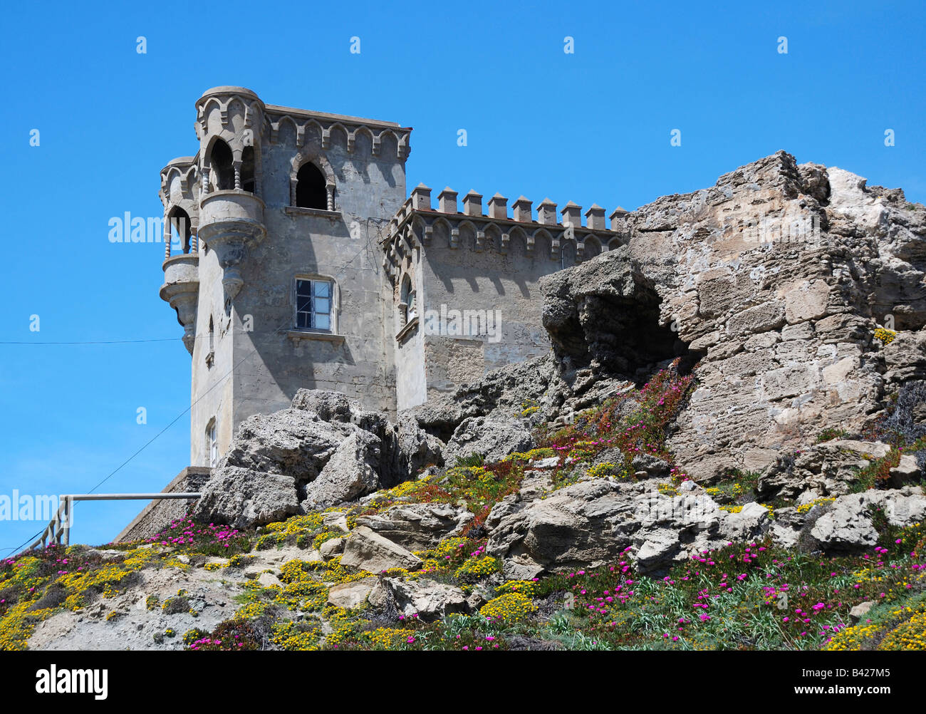 Moresque building on stony hill moss-grown against blue sky, Castle of Guzman el Bueno Stock Photo