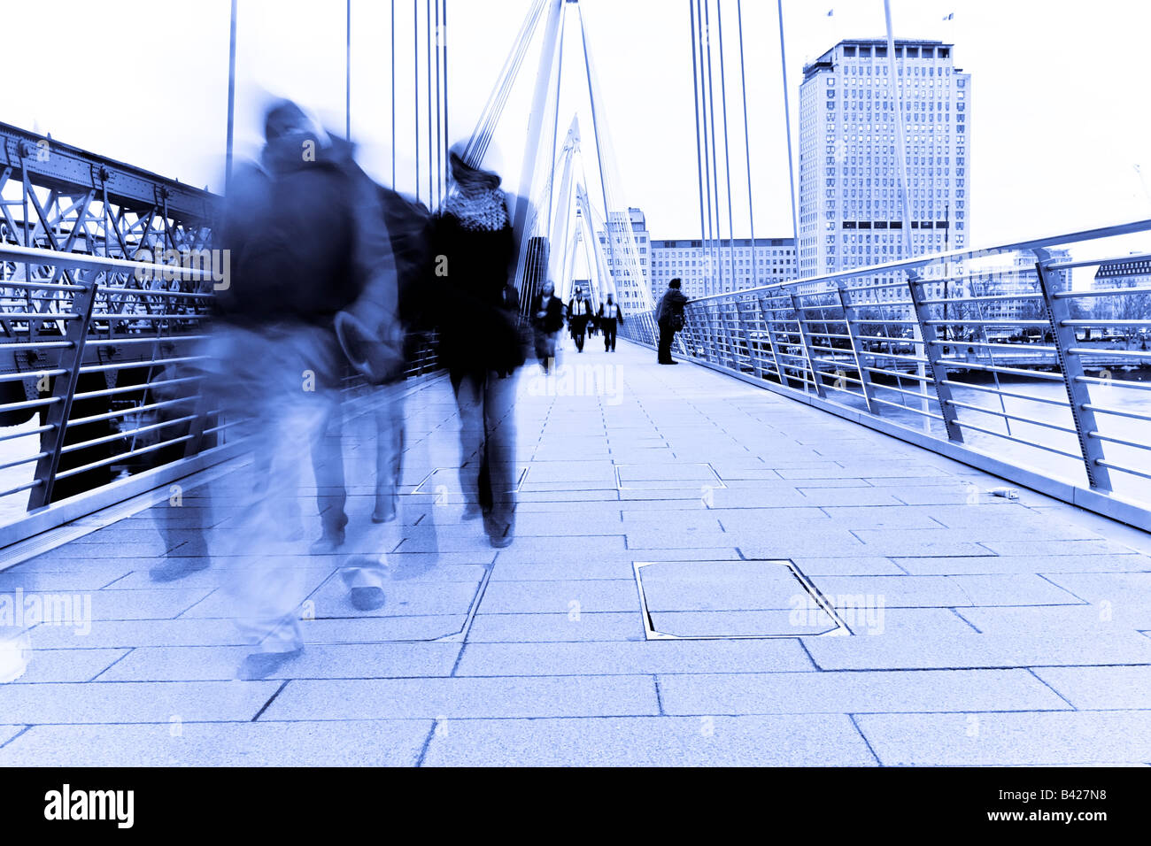 Blurred people walking over the bridge Stock Photo Alamy
