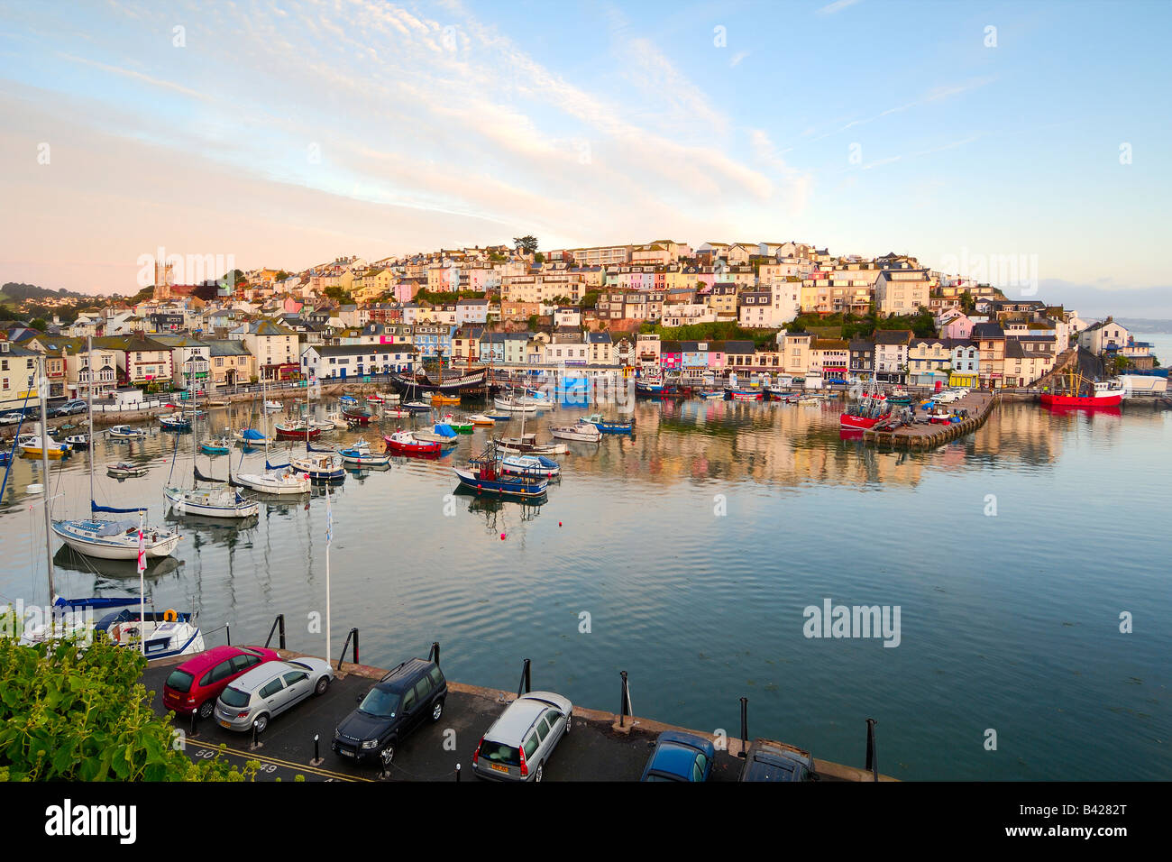 The small fishing town of Brixham on the South Devon coast at sunrise with a beautiful early morning sky Stock Photo