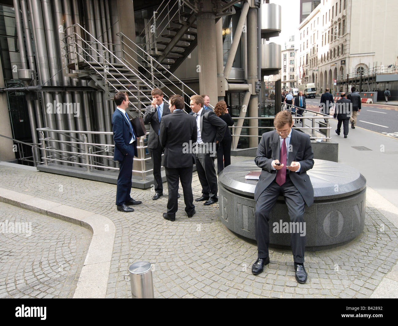 Businessmen networking in front of the Lloyds building in the London city UK Stock Photo