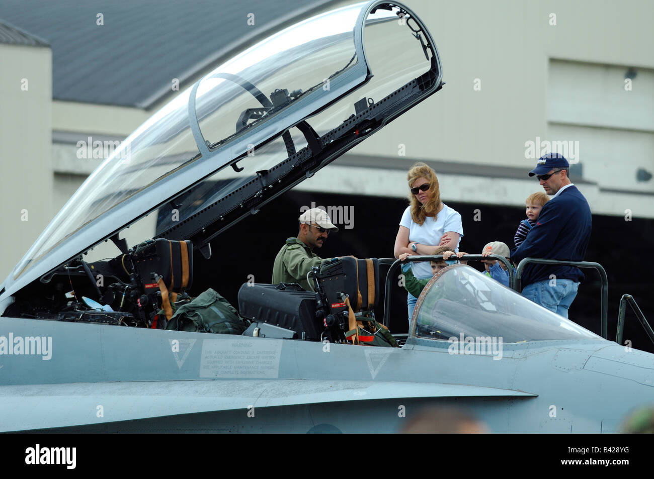 American jet fighter F-18 Hornet cockpit with pilot and american family, Anchorage air show, Alaska, Usa Stock Photo