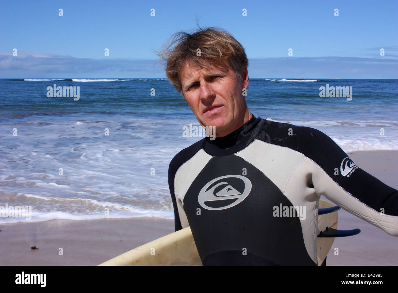 a surfer explaining to me that there are no sharks here at this beach in australia Stock Photo