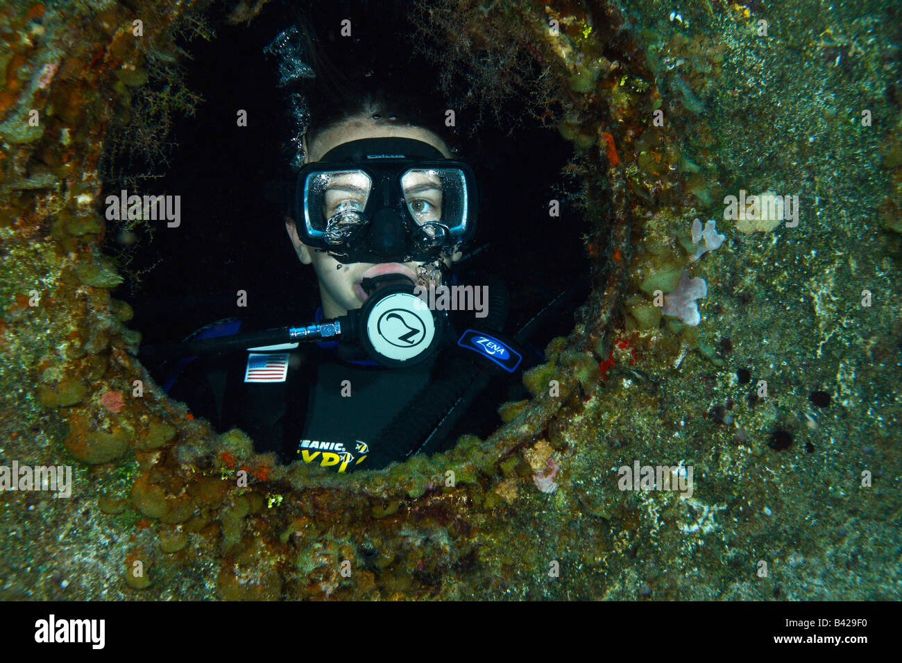 Young teenage female diver exploring the internal compartments of a ship wreck 'Felipe Xicotencatl' Stock Photo