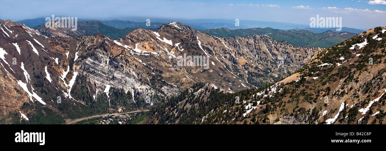 Wasatch Mountains in Utah during early summer. Patch snow, pine trees and forest. Panorama. Stock Photo