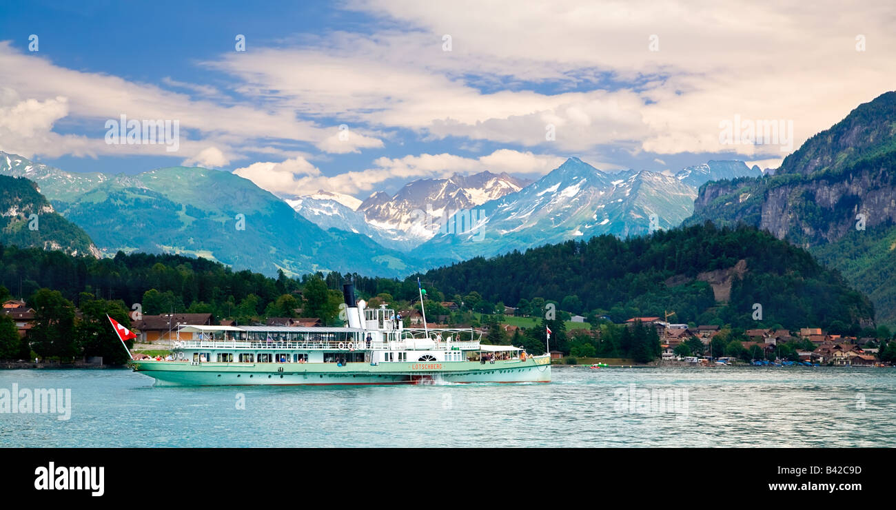 A steam boat is cruising on Brienz Lake in the district of Interlaken ...