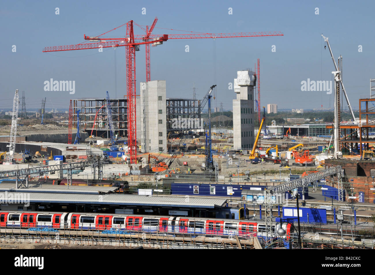 Semi aerial view of Stratford East London Westfield shopping centre complex and Olympic park building site beyond train station Stock Photo