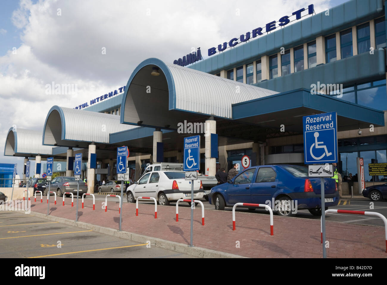 Bucharest Romania Otopeni Airport international departures building exterior with empty disabled parking bays in car park Stock Photo