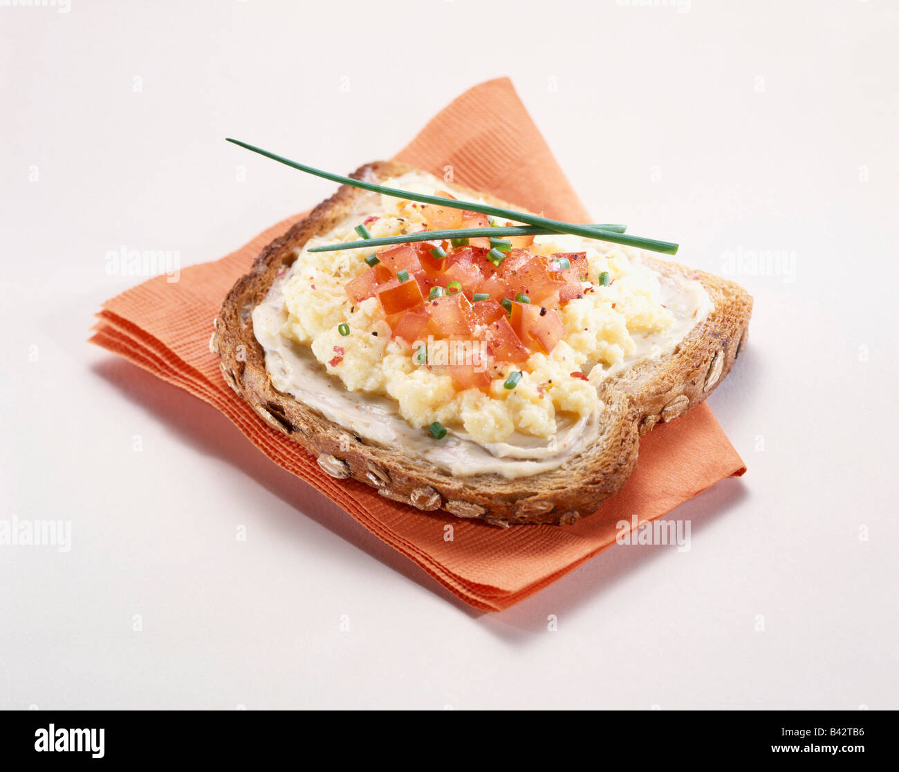 Scrambled egg and tomato open sandwich Stock Photo Alamy