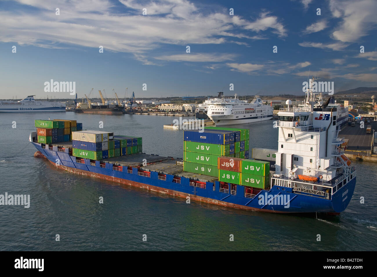 Cargo ship carrying containers departing Port of Civitavecchia, Italy, the Port of Rome Stock Photo